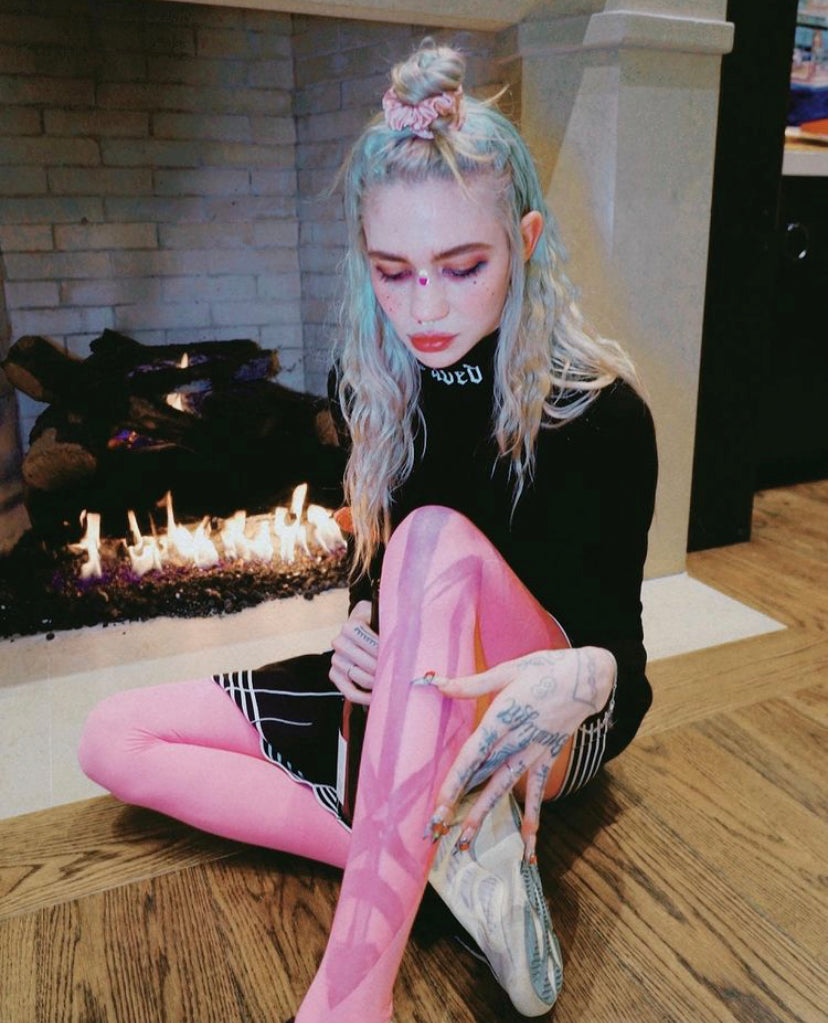 GRIMES WEARING ‘POMMES FRITES’ TIGHTS